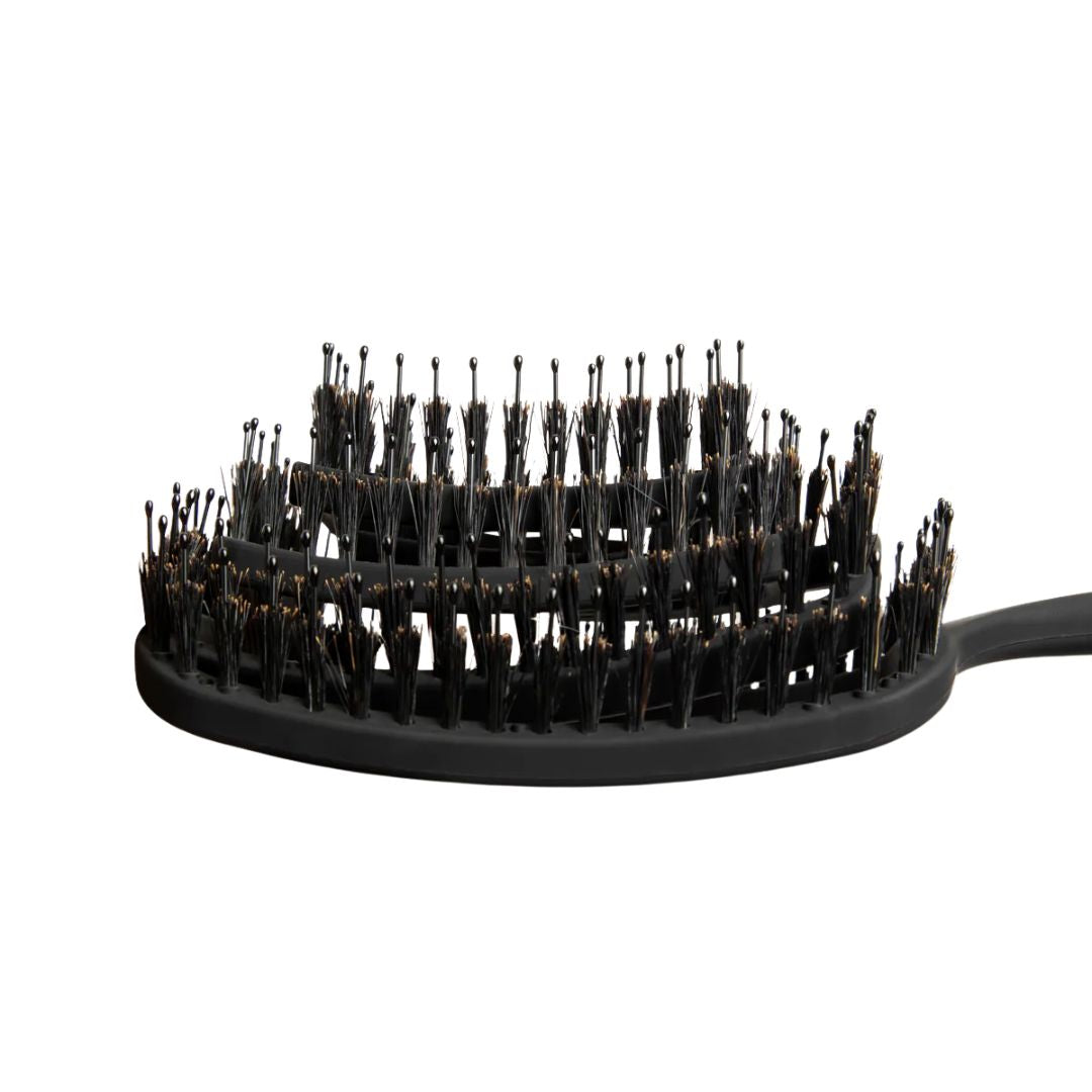 Black hairbrush with bristles on a white background