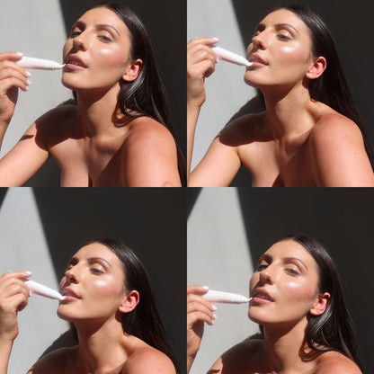 Four-panel collage showing a woman applying a white cosmetic product from a tube to her lips. She is bare-shouldered against a sunlit gray wall, with the product tube visible in each panel.