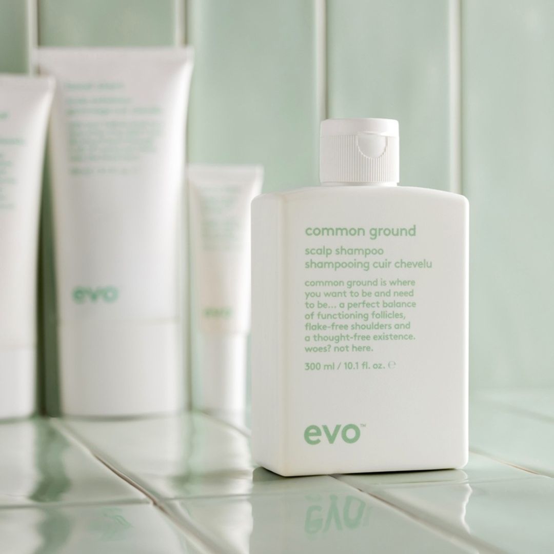 evo common ground scalp shampoo bottle on a tiled surface
