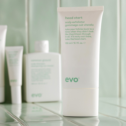 evo head start scalp exfoliator tube on a bathroom counter with other evo products.