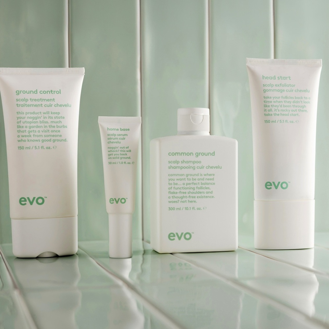 evo hair care products on a tiled surface with a light green wall background