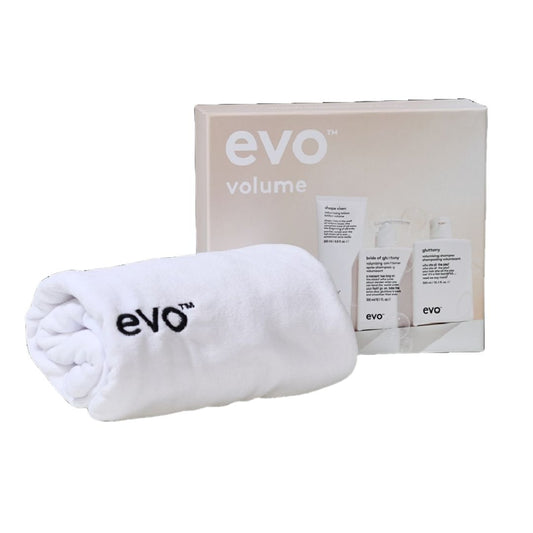 evo volume hair product set with a white towel on a white background