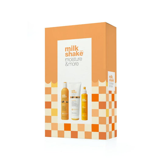 Milk Shake Moisture & More gift set box, featuring orange and cream checkered patterns with a white central label showing the brand name and product bottles.