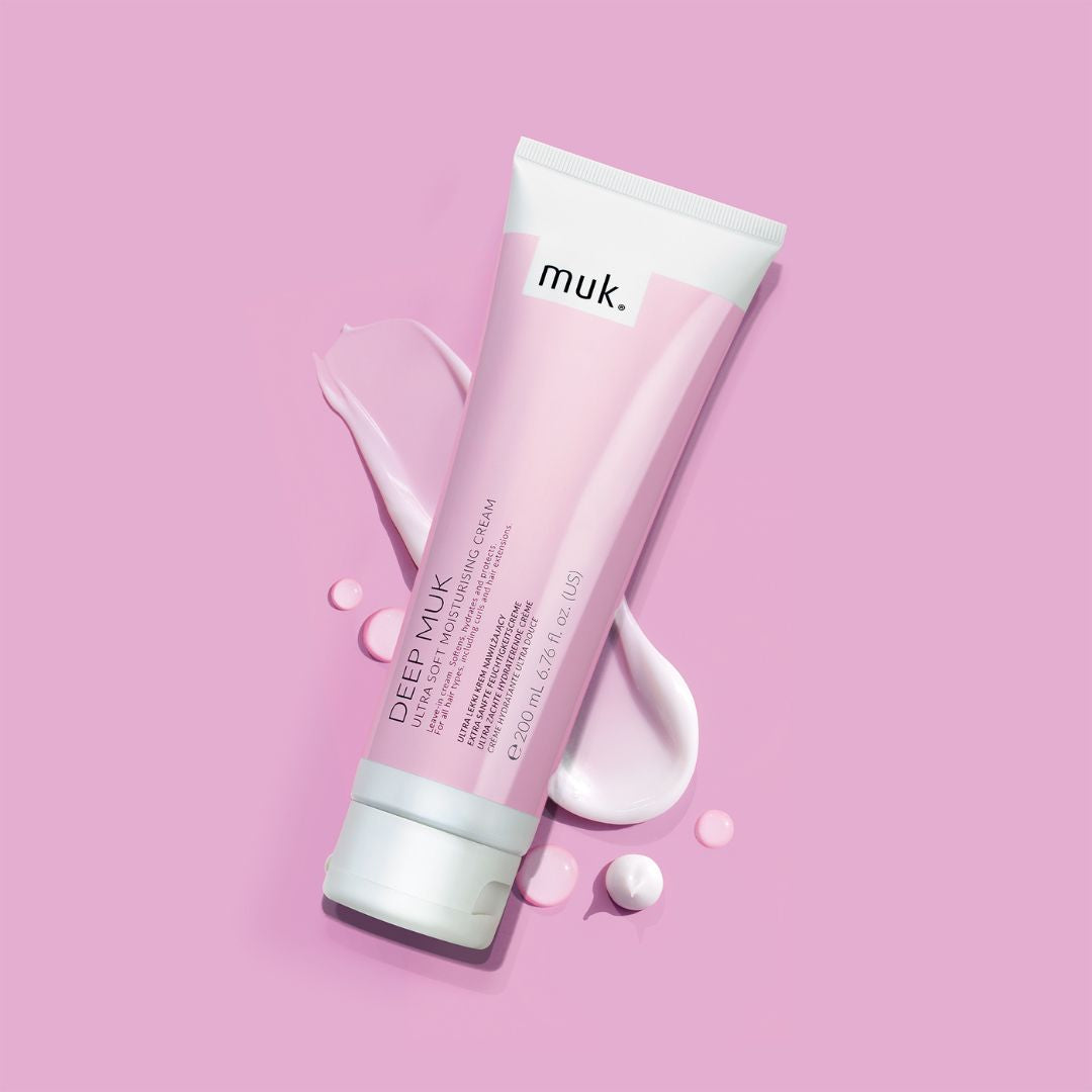 Tube of 'muk.' Deep Muk cream on a pink background