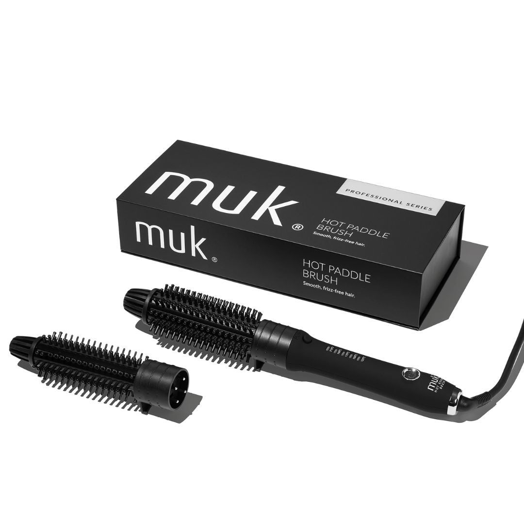 Black hot paddle brush with packaging labeled 'muk' on a white background