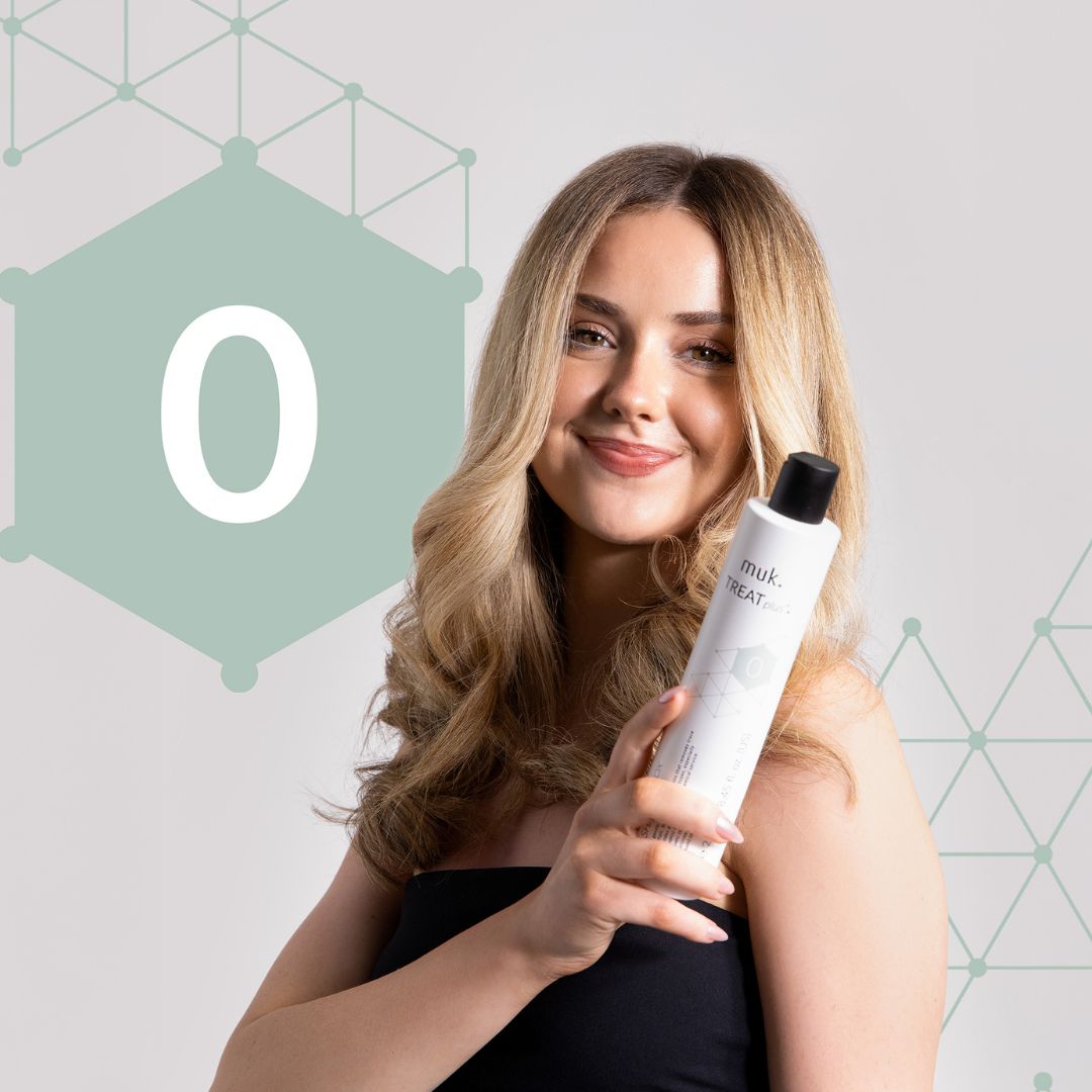 Woman holding a muk hair care product with a geometric design in the background