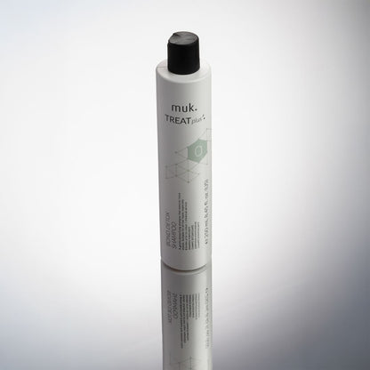 Muk Treat Plus hair product bottle on a gradient gray background