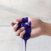 Biolage ColorLast Purple Shampoo 400ml in hand dripping